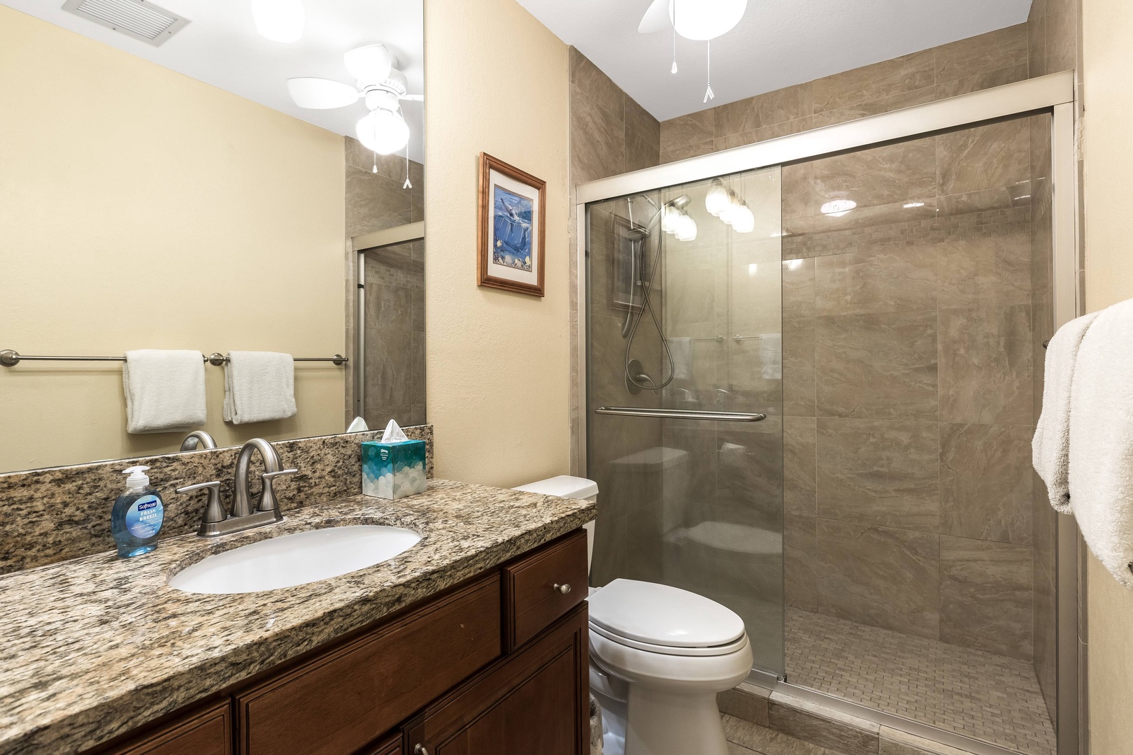 Step into your spotless, spa-like bathroom with sleek granite counters, a spacious walk-in shower, and soft towels waiting just for you.