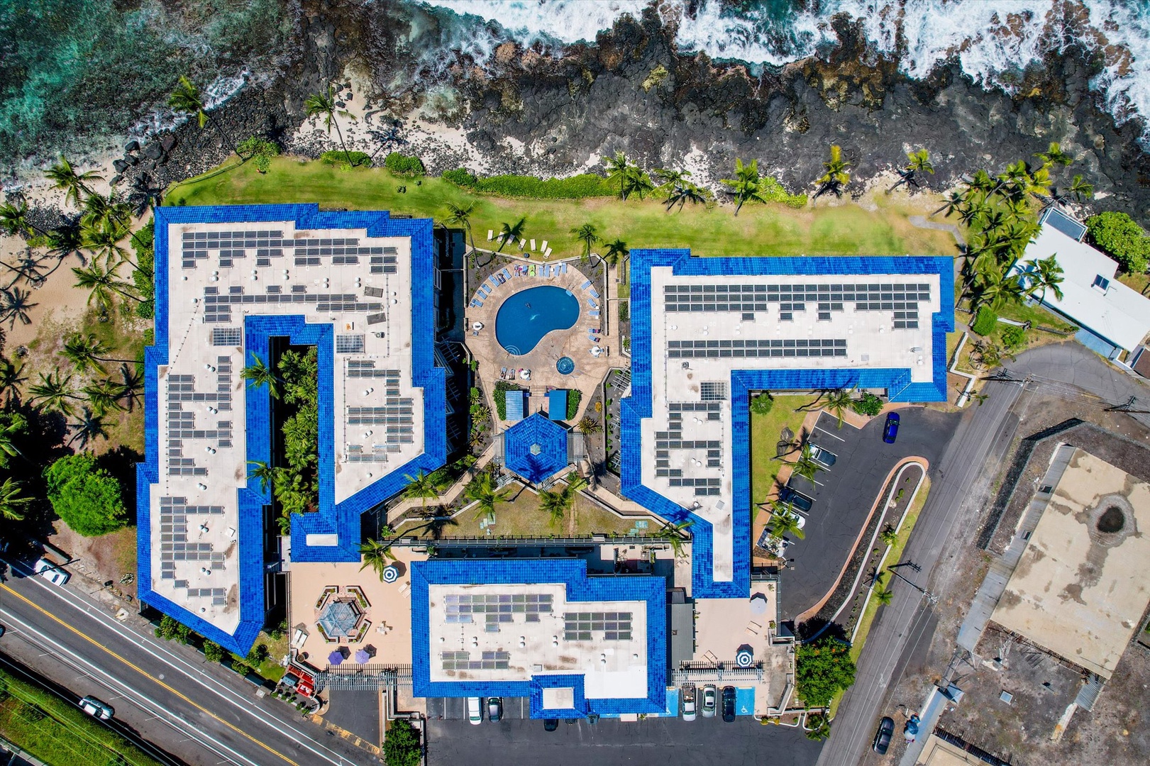 Kona Reef features a pool and lush landscaping along a dramatic volcanic coastline.