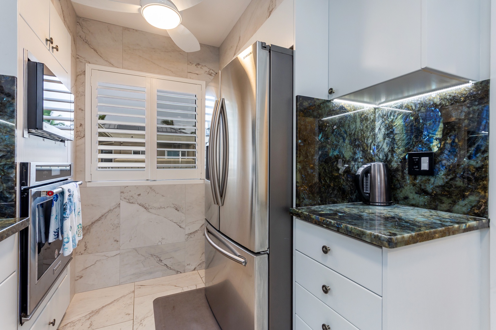 Your fully equipped kitchen features stunning granite countertops, modern stainless steel appliances, and elegant marble-inspired flooring—everything you need to prepare meals in style and comfort.