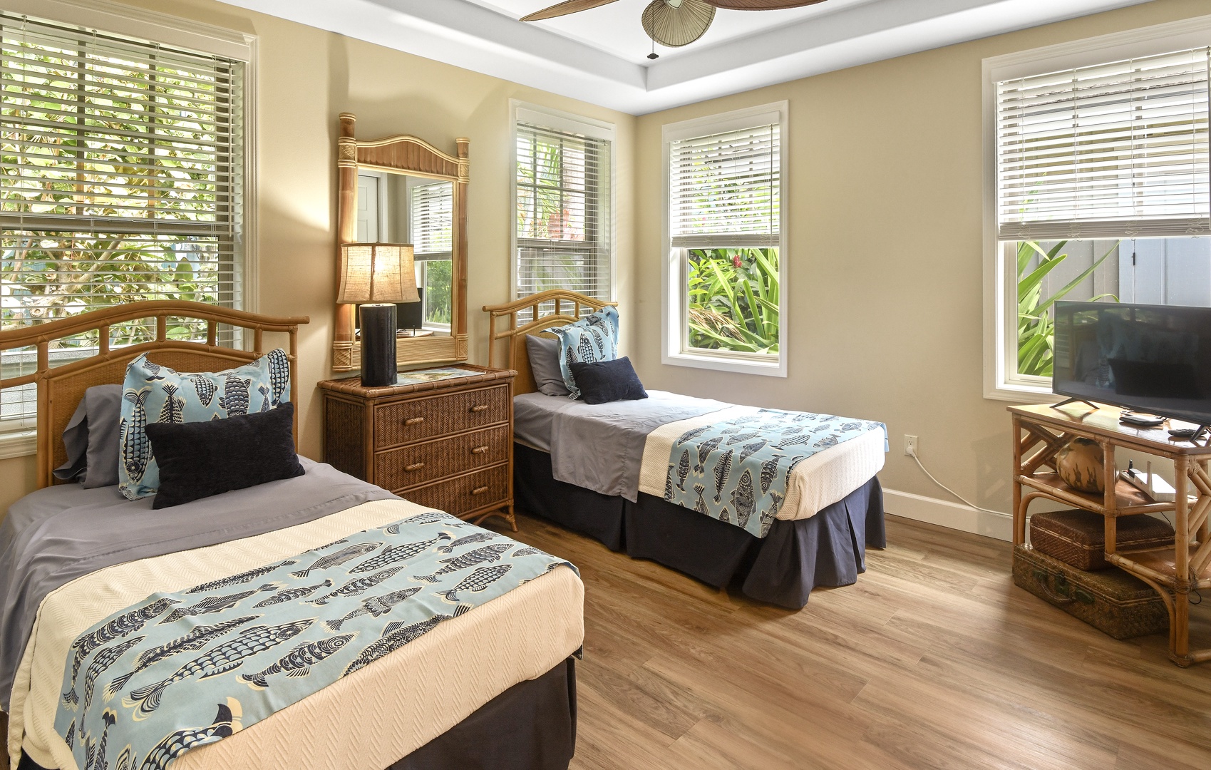 Unwind in your bright twin bedroom with tropical touches, bamboo furnishings, and natural light filtering through plantation shutters.