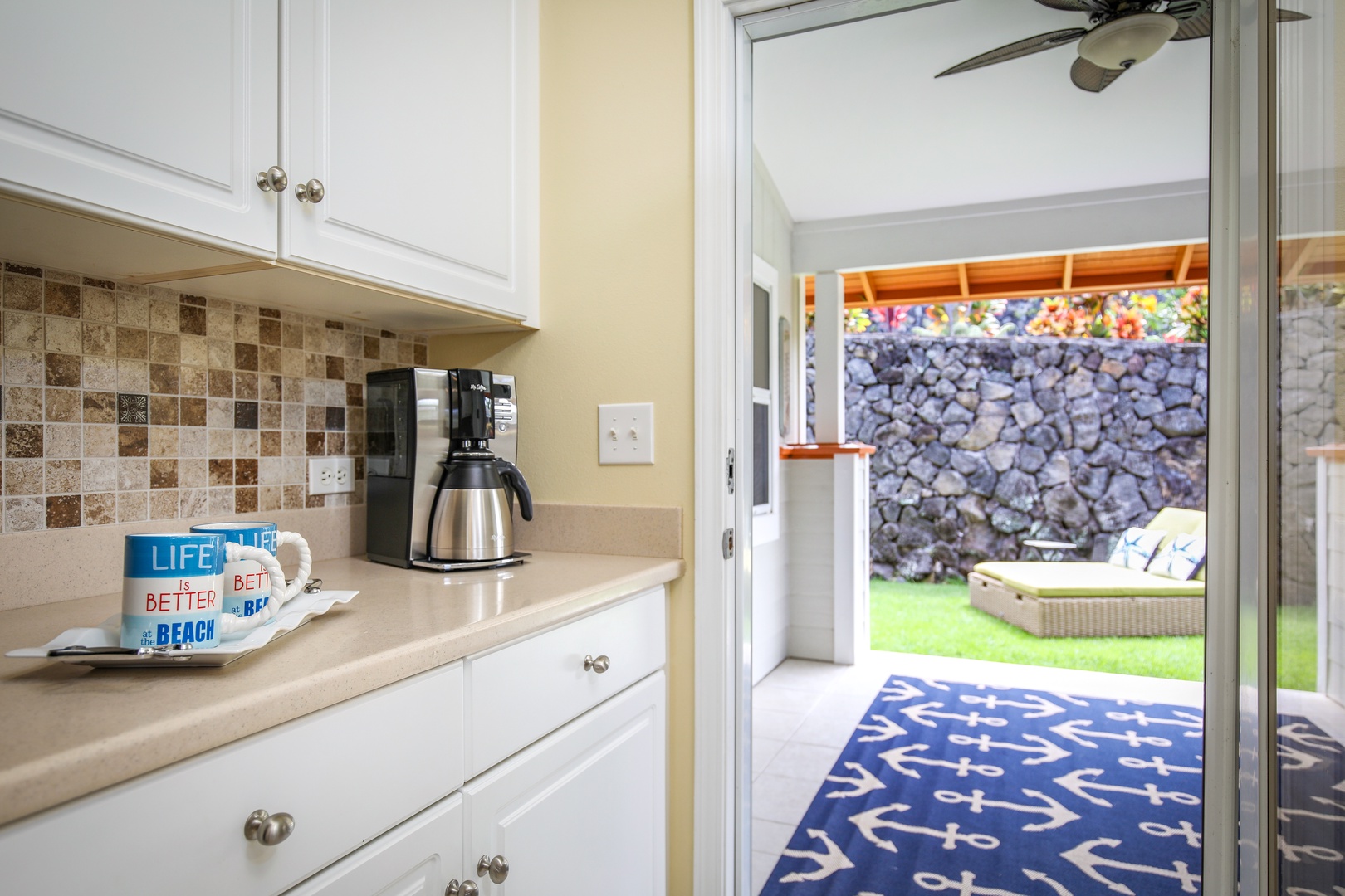 Step from your bright kitchen into your private outdoor retreat, where sunshine and a lush lawn invite you to unwind with your morning coffee in hand.