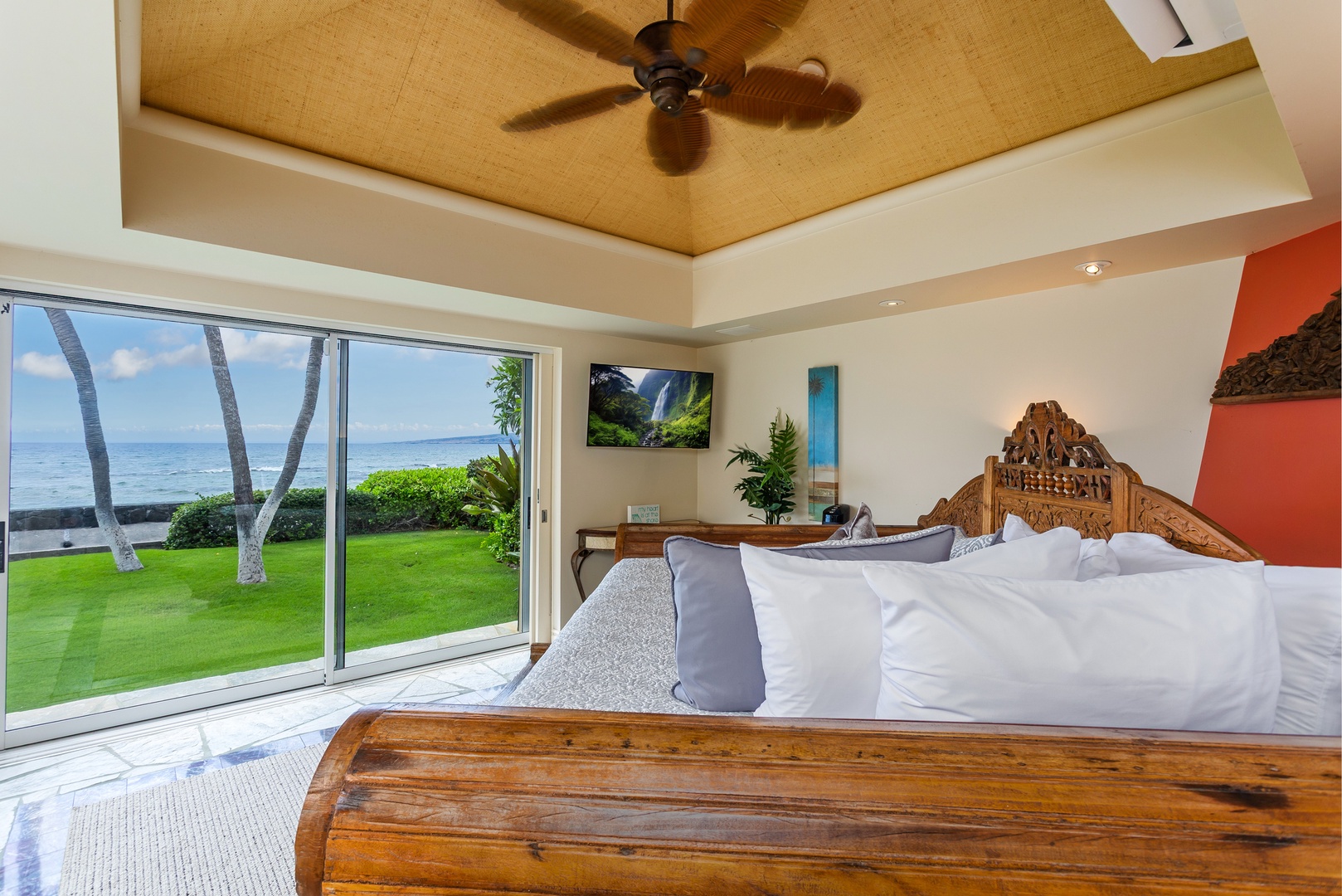 Ohana (Guest House) - Wake up to stunning ocean views framed by swaying palms from your elegant bedroom, where a hand-carved headboard and soft linens create your personal island sanctuary overlooking lush lawns and endless blue waters.