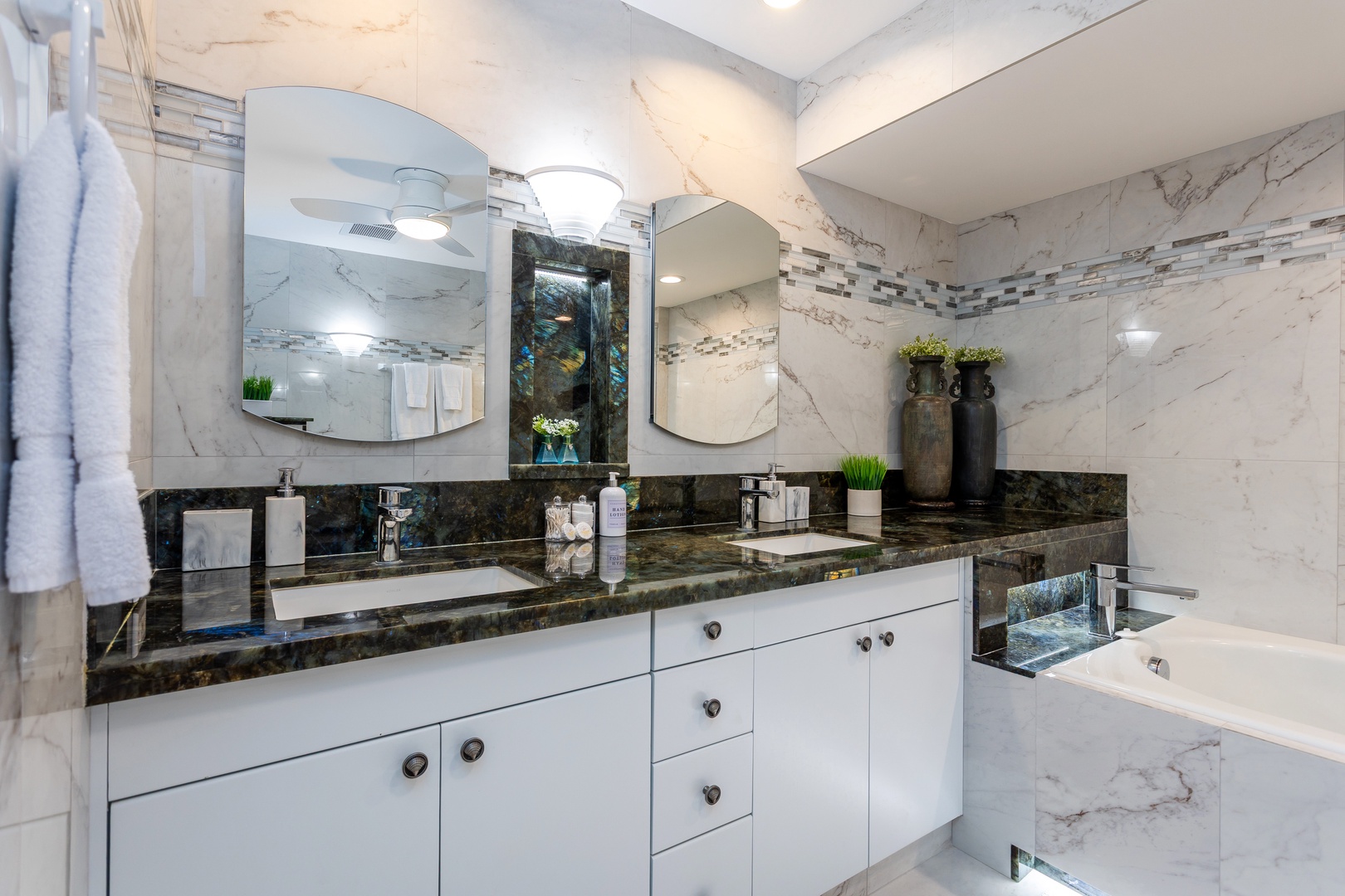 Unwind in your marble-clad sanctuary with dual vanities, sleek fixtures, and a soaking tub ready for your relaxation rituals.