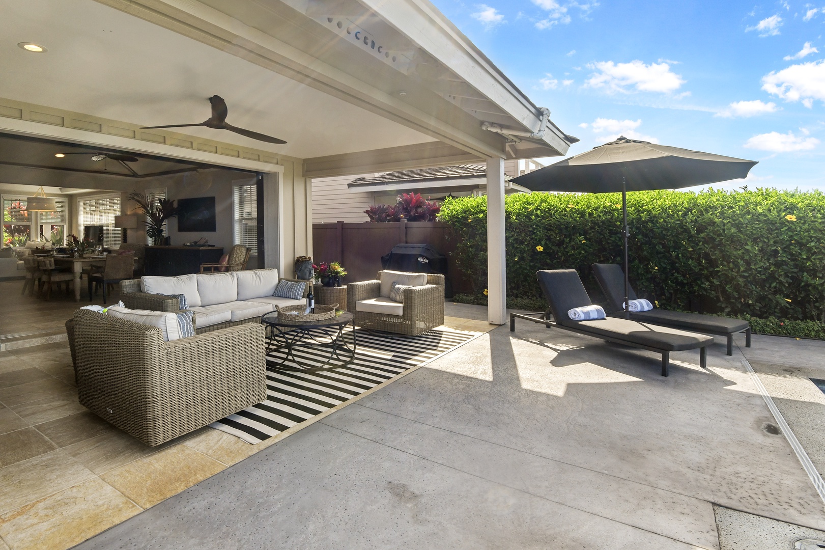 Relax in your private covered lanai with stylish outdoor furniture and lounge chairs, perfect for morning coffee or evening drinks.