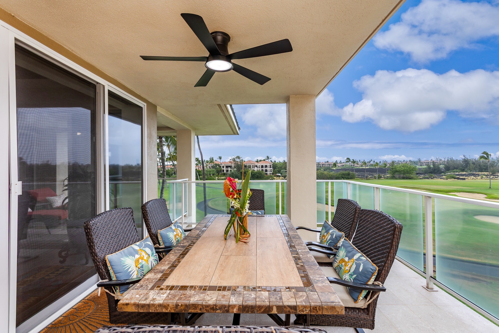Dine al fresco on your private balcony with sweeping golf course and tropical landscape views. The covered terrace offers comfortable seating for six, perfect for morning coffee or sunset gatherings.