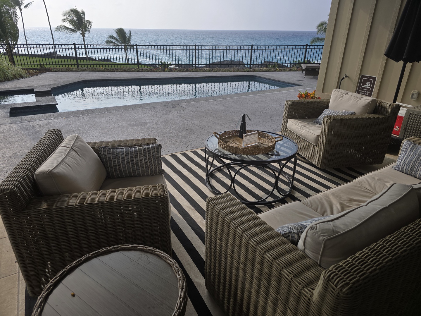 Unwind in your private oceanfront terrace where wicker seating overlooks the infinity pool and endless sea views.