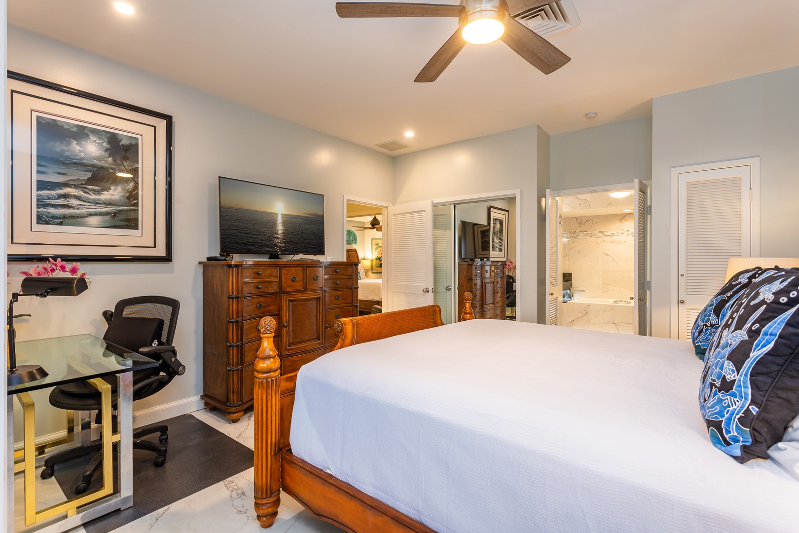 Unwind in your coastal-inspired bedroom where calming tones and crisp linens invite restful sleep. The workspace and ceiling fan add comfort and convenience to your stay.