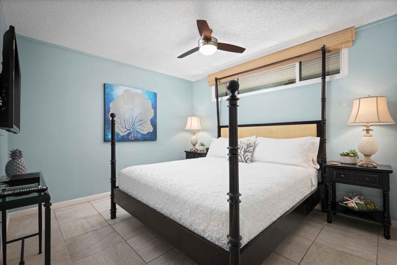 Unwind in your coastal-inspired bedroom, where soft blue walls and a plush four-poster bed invite you to relax after a day of exploring.