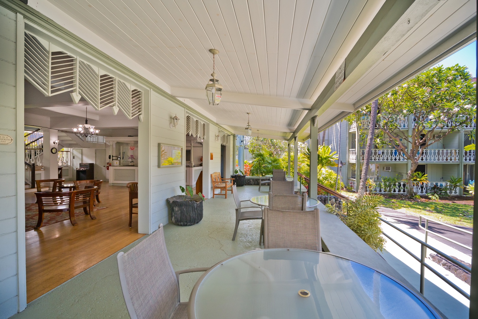 Relax at the covered patio, where coastal breezes meet elegant indoor-outdoor living. Sip morning coffee at the outdoor dining table while gazing at lush tropical gardens.