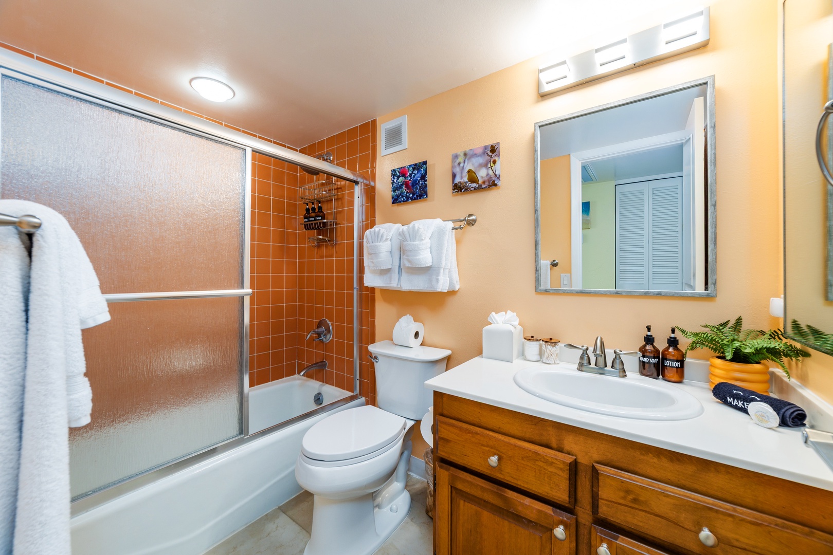 Relax in your private bathroom with warm lighting, fresh towels, and thoughtful touches—complete with a tub-shower combo and a vanity stocked with everything you need.