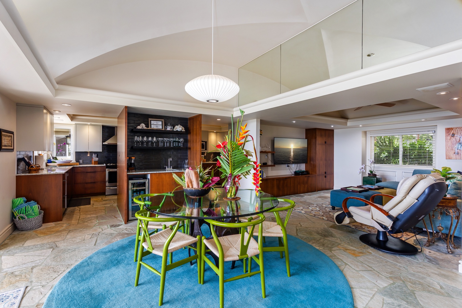 Open-concept elegance welcomes you with rich wood cabinetry, designer furnishings, and pops of vibrant color throughout this stylish and sun-filled living space.