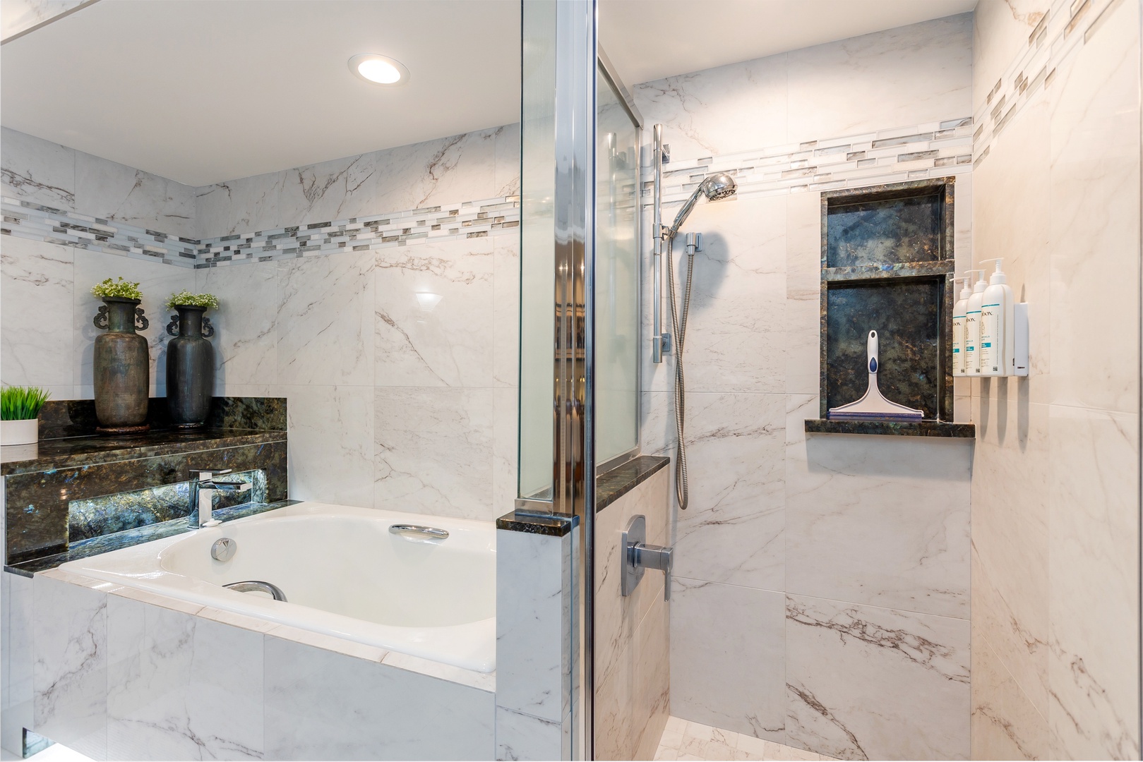 Unwind in your spa-inspired marble bathroom with a soaking tub and walk-in shower featuring elegant tile accents and built-in niches for your essentials.