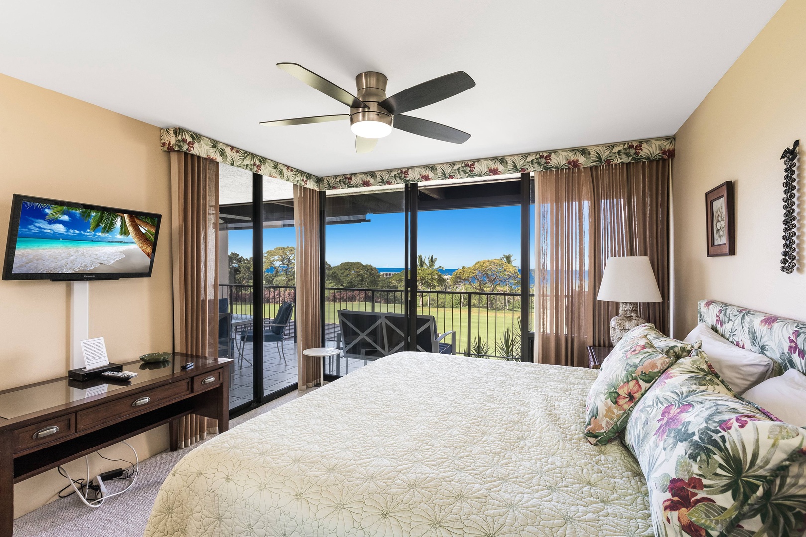Wake to ocean breezes in your serene bedroom retreat, where tropical décor and island views create a tranquil escape. Step onto your private balcony to enjoy morning coffee surrounded by lush greenery.