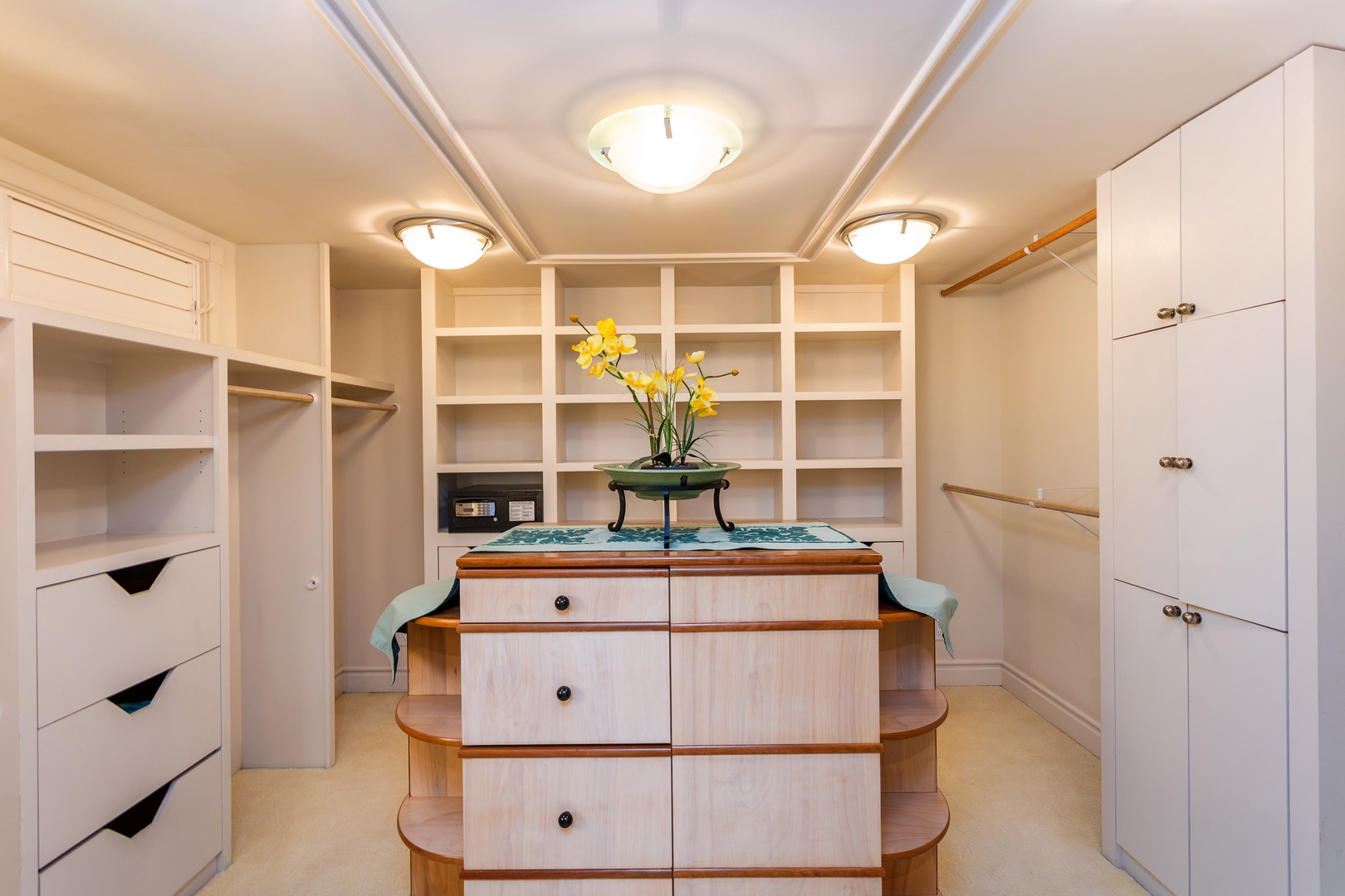 Primary Bedroom - Your walk-in closet offers abundant storage with custom shelving, elegant lighting, and a charming center island for organizing your wardrobe with ease.