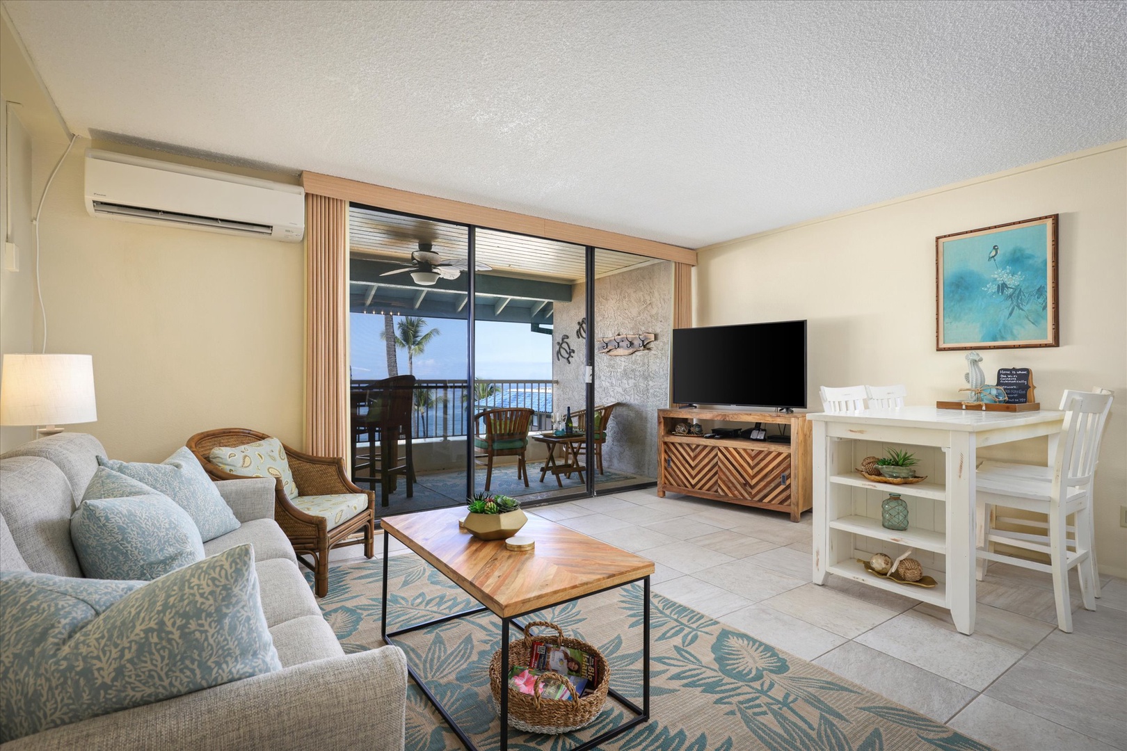 Unwind in your coastal-inspired living space, where ocean breezes drift through sliding doors to your private lanai, or relax on the plush sofa while enjoying modern entertainment.