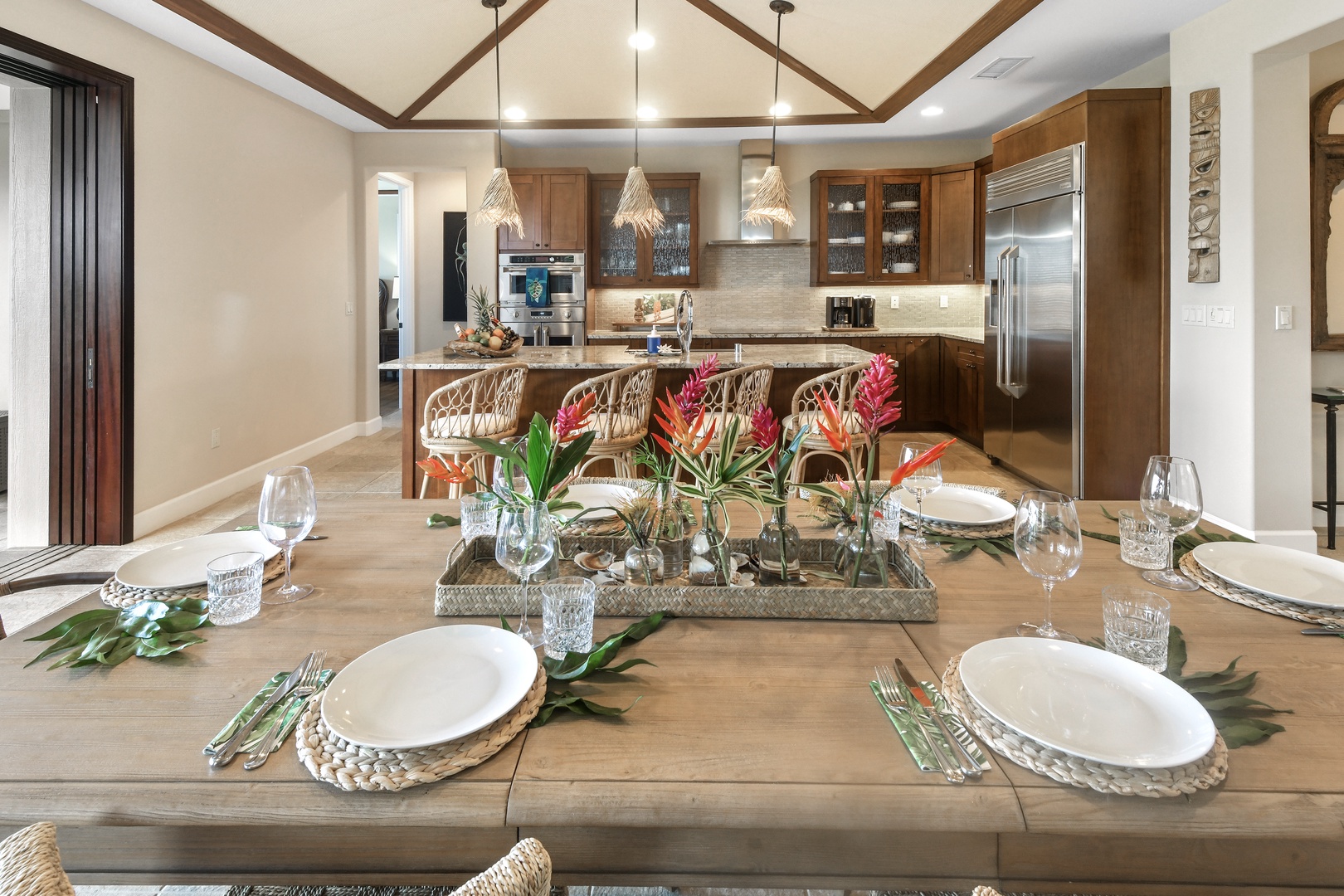 Gather around this stunning dining table where memorable meals await, perfectly set for your group with beautiful tropical touches.