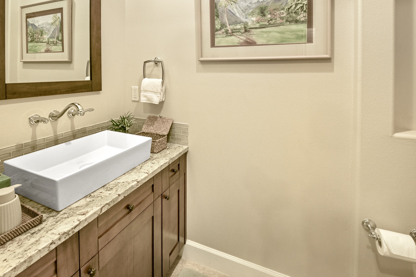 Refresh in your elegantly appointed bathroom featuring granite countertops, vessel sink, and tasteful artwork creating a spa-like atmosphere.