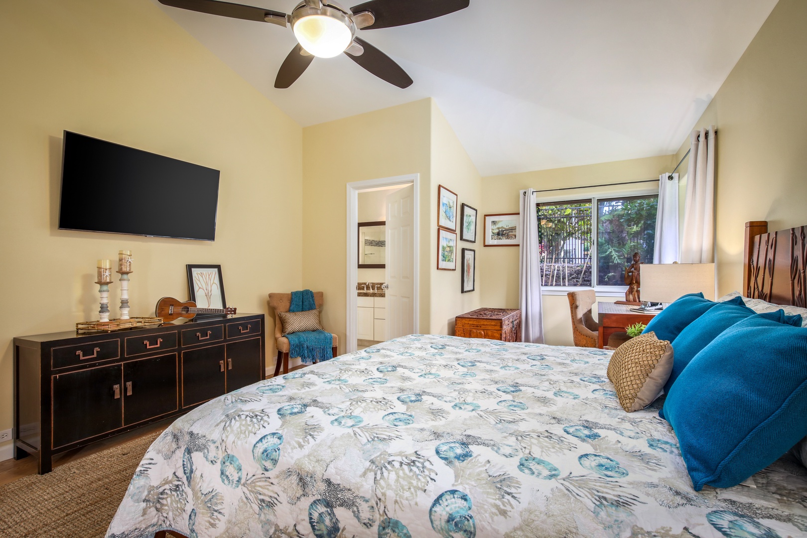 Unwind in your restful bedroom with a plush bed, charming décor, and a ceiling fan to keep you comfortable. Natural light streams through the window, and your private en-suite awaits.