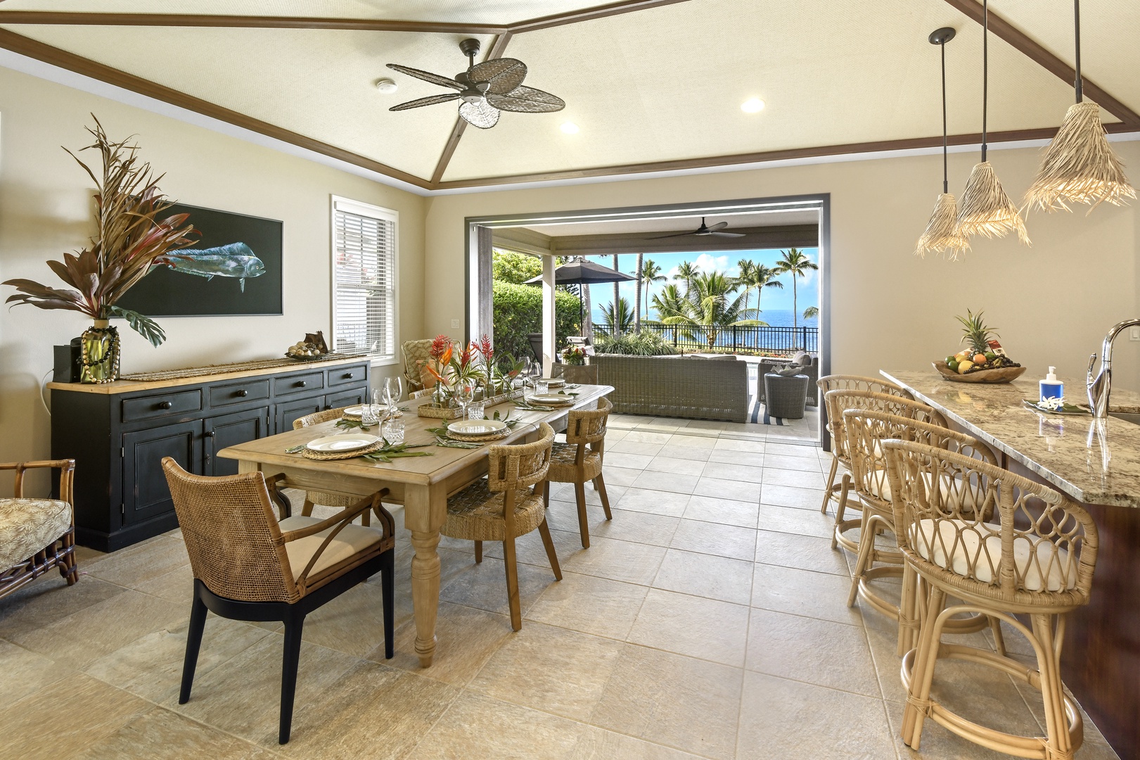 Your tropical dining space opens to ocean views, where coastal breezes flow through while you savor meals at the elegant table.