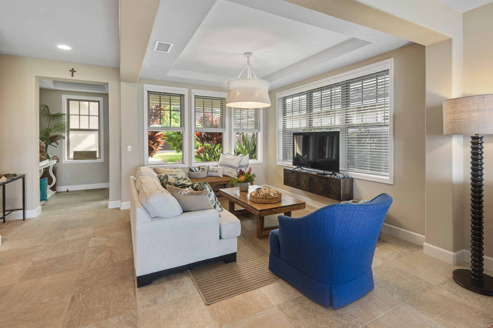 Sink into plush seating while natural light flows through windows, creating your perfect retreat for relaxation and entertainment.