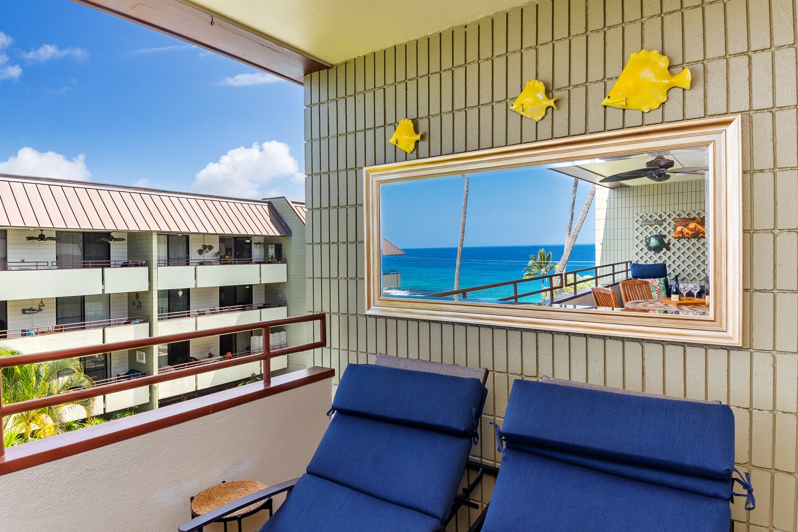 Unwind on your private balcony with two cushioned loungers, cheerful tropical fish décor, and sweeping ocean views that invite you to relax and soak in the island breeze.