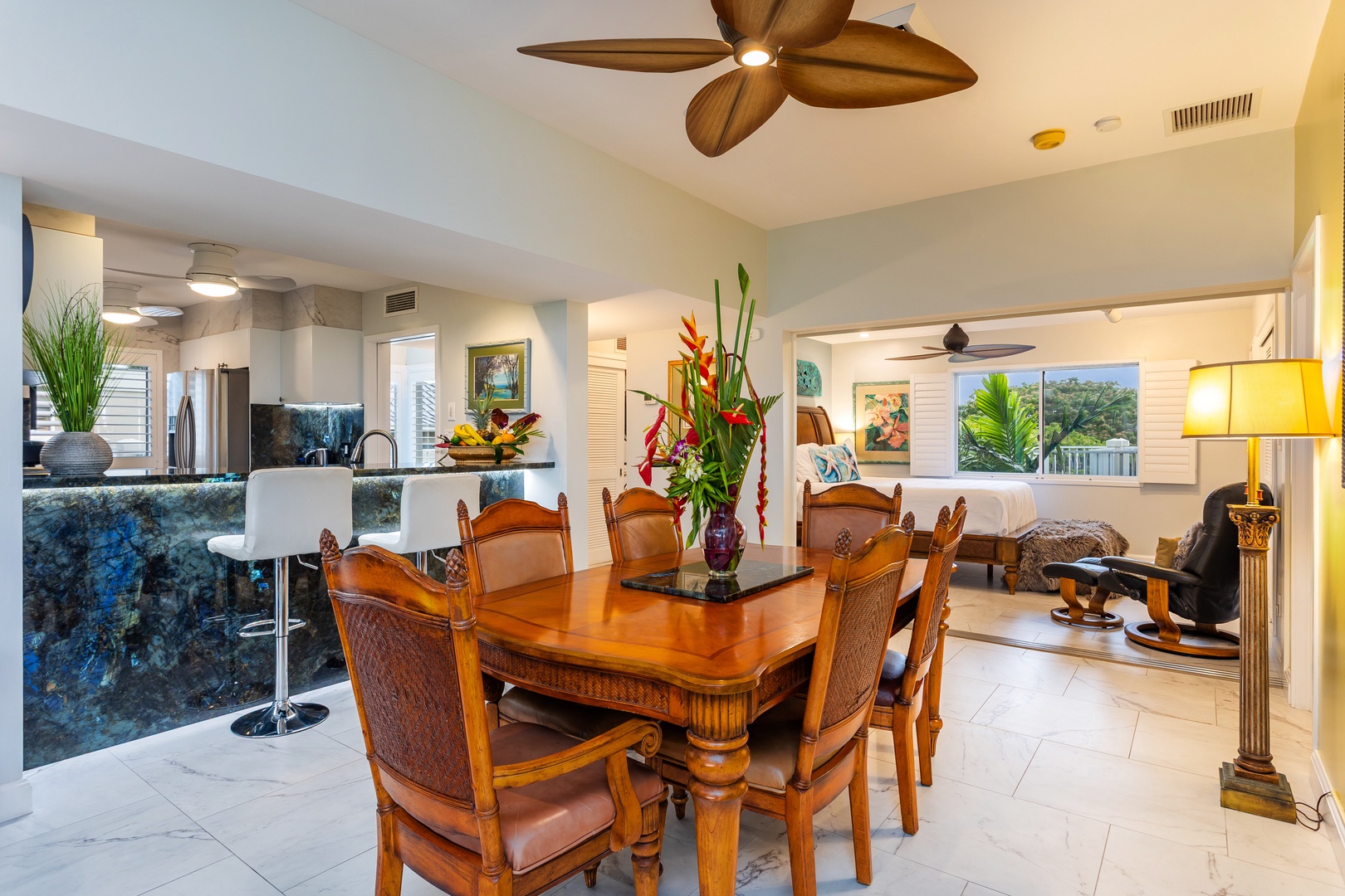 Gather around a beautifully crafted dining table with tropical décor, elegant furniture, and an open layout that flows seamlessly into your fully-equipped kitchen and cozy living space.