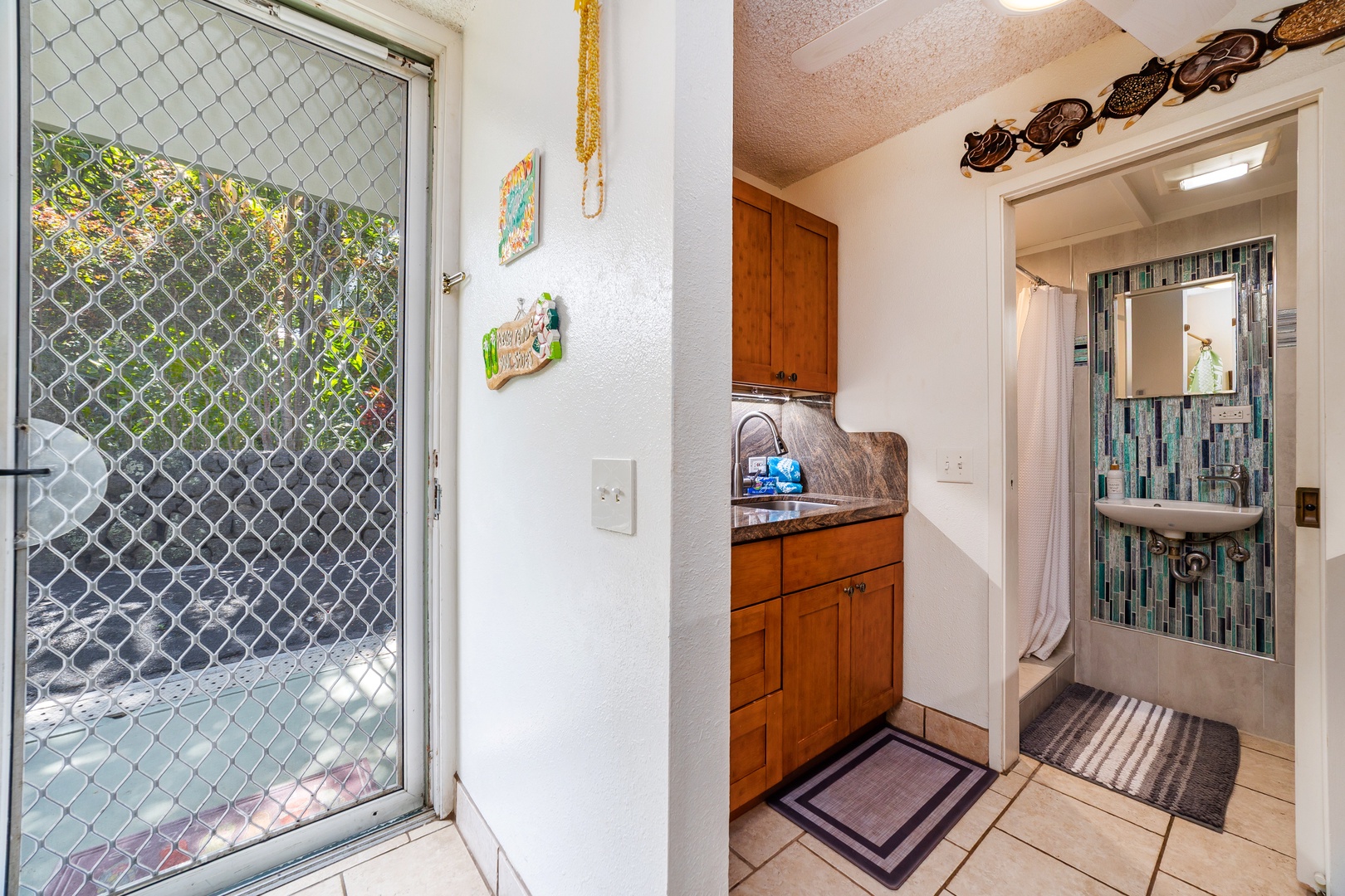 Step inside to find charming coastal touches throughout—your kitchenette and bathroom feature soothing turquoise tile, while warm wood cabinetry and cheerful accents make you feel right at home the moment you arrive.