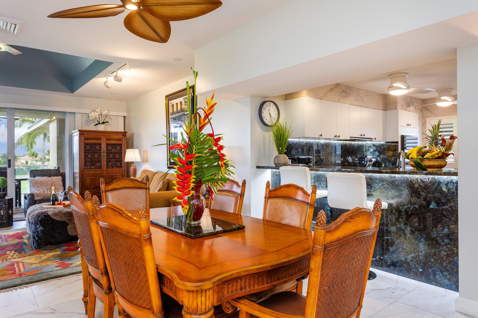 Gather around this tropical-inspired dining table, where island elegance meets modern comfort. The open-concept space flows seamlessly into your fully equipped kitchen and inviting living area.