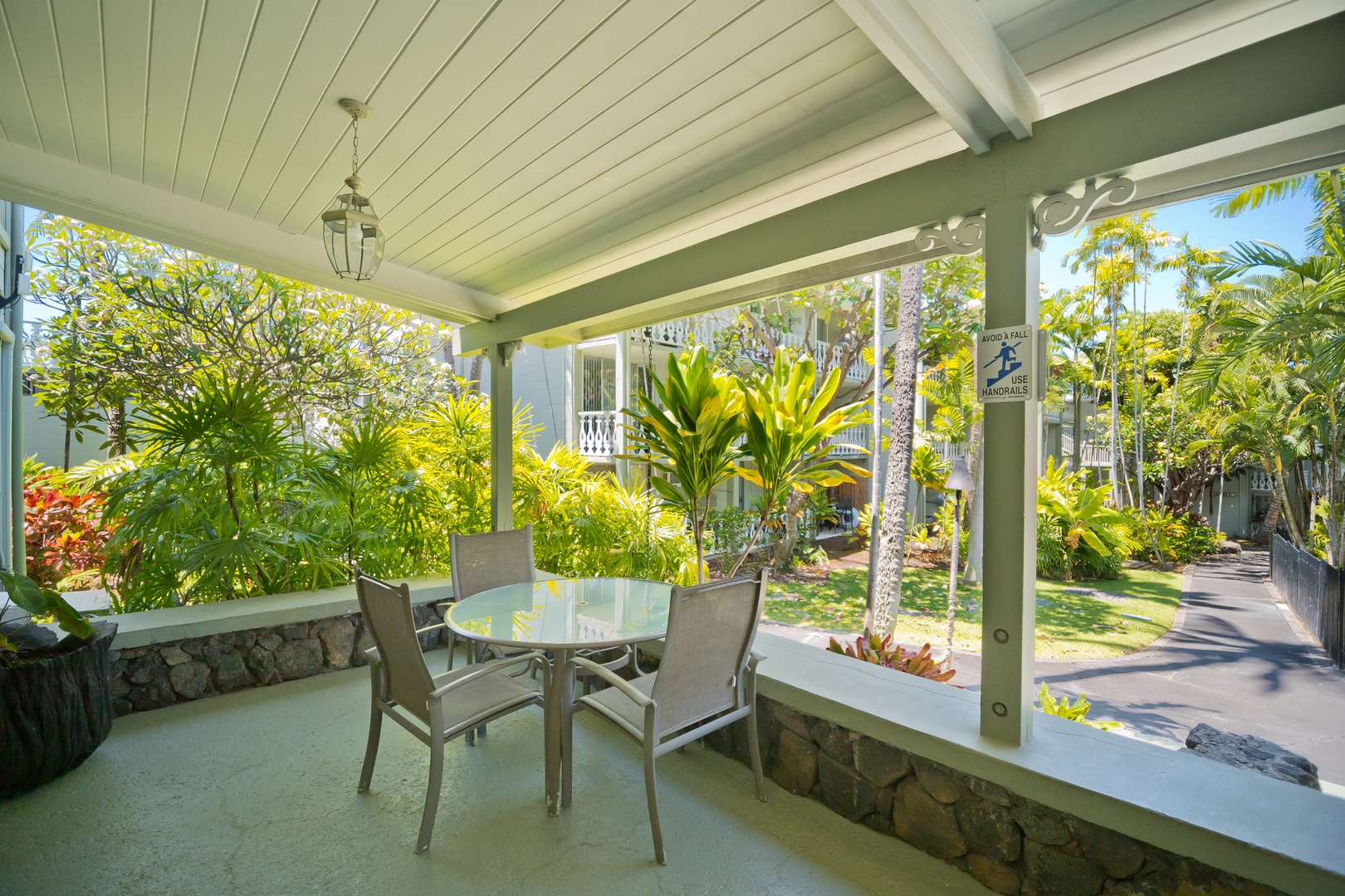 Step onto the covered patio and breathe in the tropical breeze. With lush garden views and a quiet table for morning coffee or evening relaxation, this tranquil outdoor space is all yours.