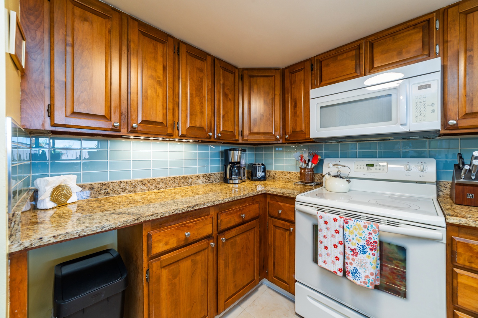 Your fully equipped kitchen features rich wood cabinetry, granite countertops, and modern appliances—everything you need to prepare delicious meals during your stay.