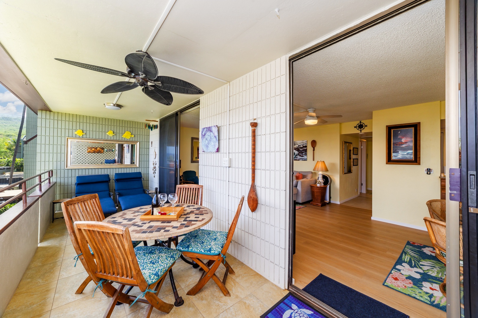 Your private balcony blends indoor and outdoor living with comfortable seating, a dining table, and lush mountain scenery framing your retreat.
