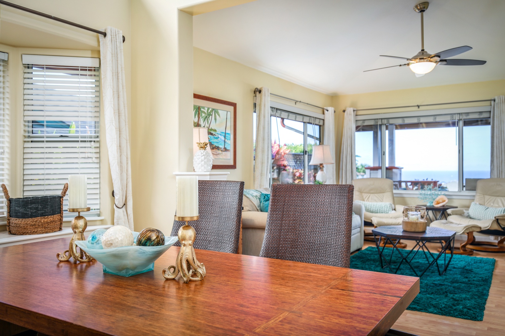 Step into your bright, coastal-inspired retreat where ocean breezes meet comfortable living. Natural light pours through large windows, framing serene water views while you unwind in this thoughtfully decorated space.