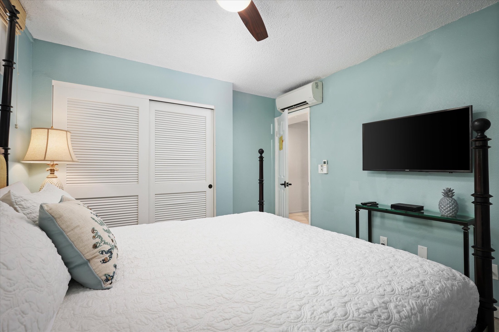 Unwind in your serene bedroom, where soft seafoam walls and crisp linens invite you to relax. Enjoy climate-controlled comfort and your favorite shows on the wall-mounted TV after a day of adventure.