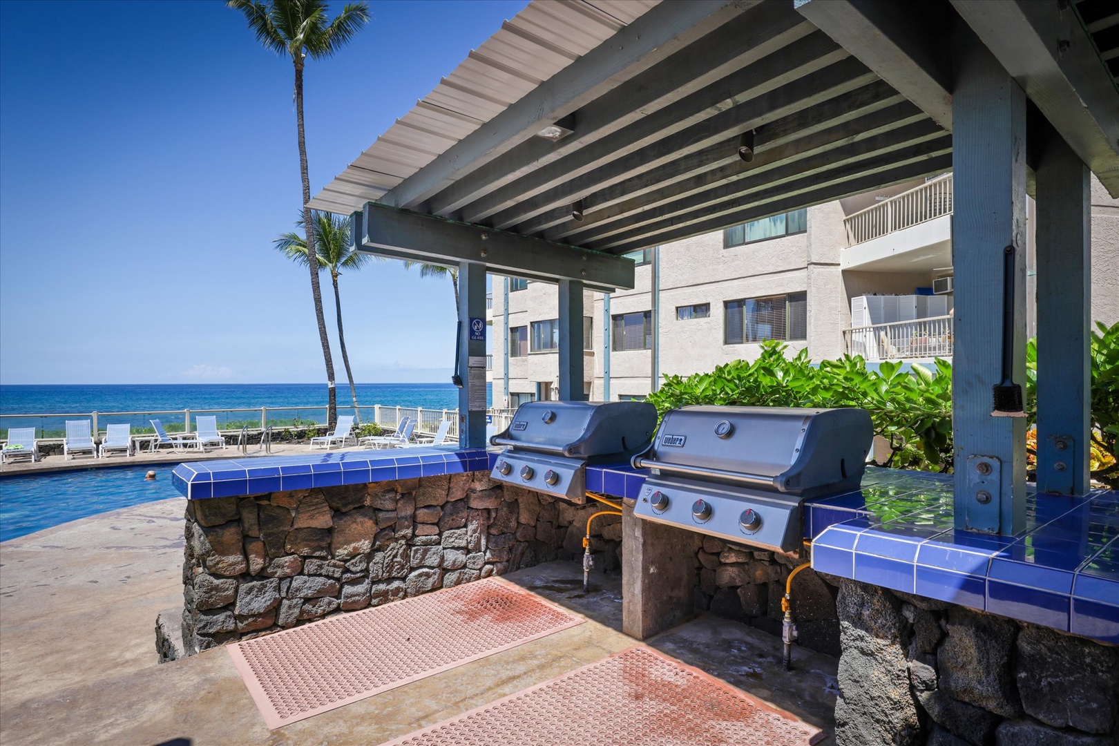 Fire up the grill under the shade while the ocean breeze surrounds you—your beachfront BBQ oasis awaits with pool views and swaying palms.