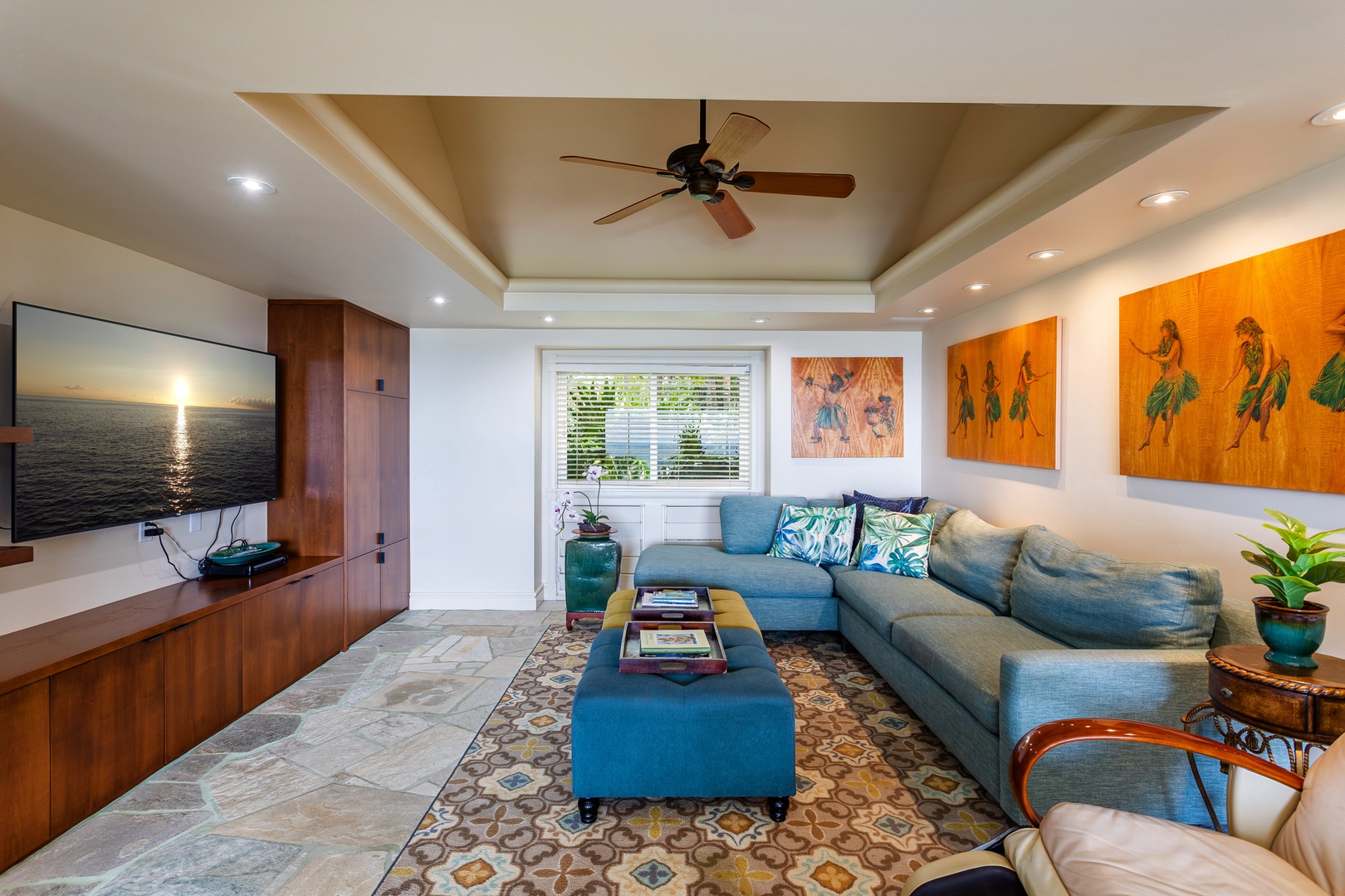 Entertainment Room - Relax in plush coastal comfort where vibrant island artwork and soft ocean breezes set the perfect backdrop for your morning coffee or evening relaxation.