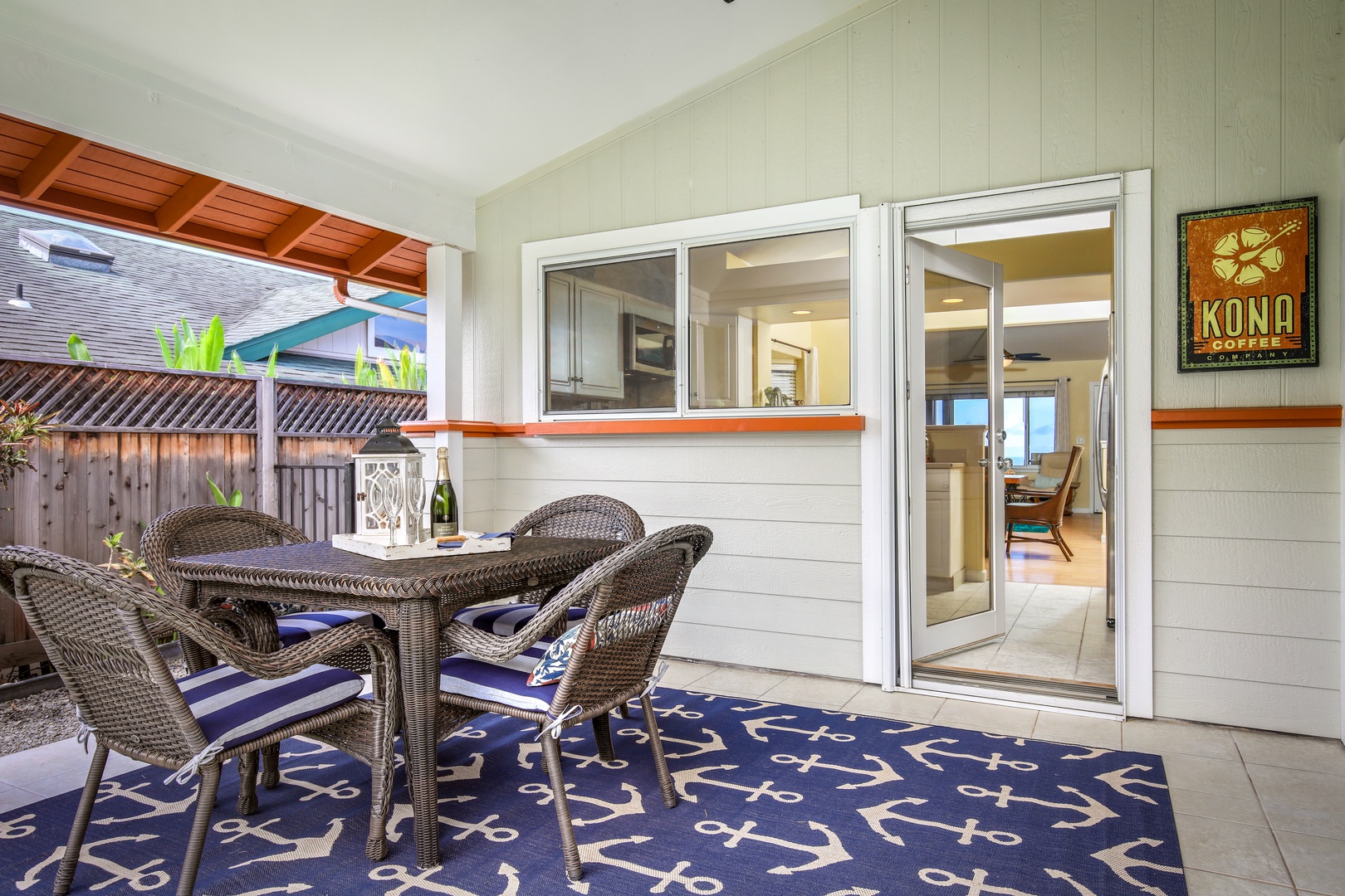 Step out to your private covered lanai where wicker seating invites you to relax with morning coffee or evening drinks. Nautical touches and tropical greenery enhance this breezy Hawaiian escape.