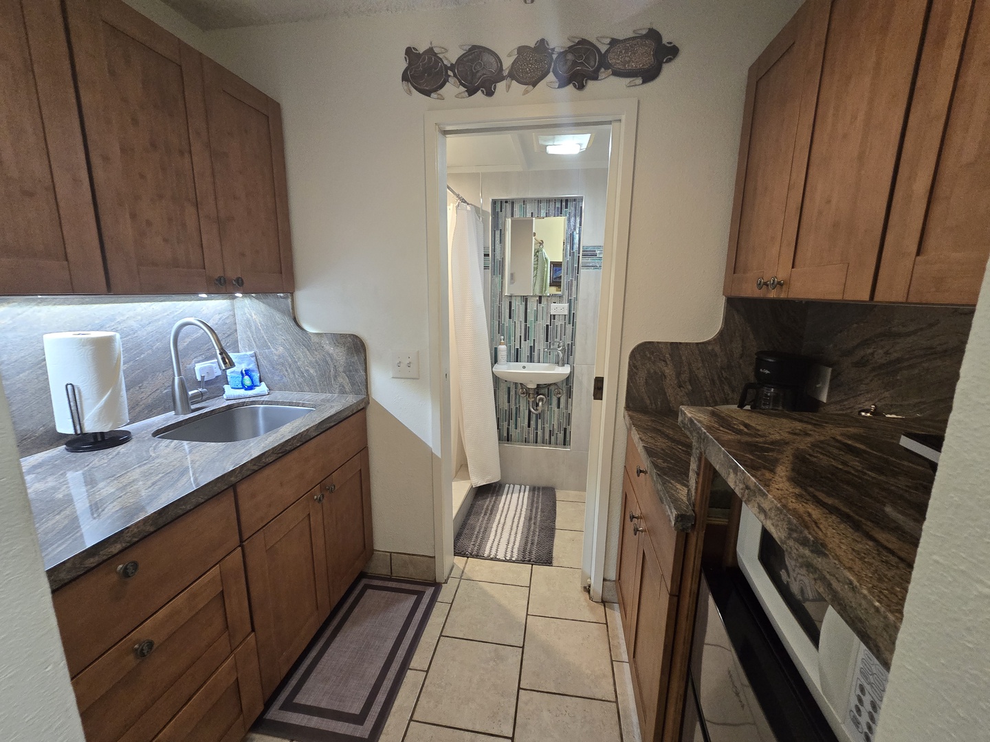Your fully equipped galley kitchen features elegant granite counters, warm wood cabinets, and everything you need to prepare meals during your stay.