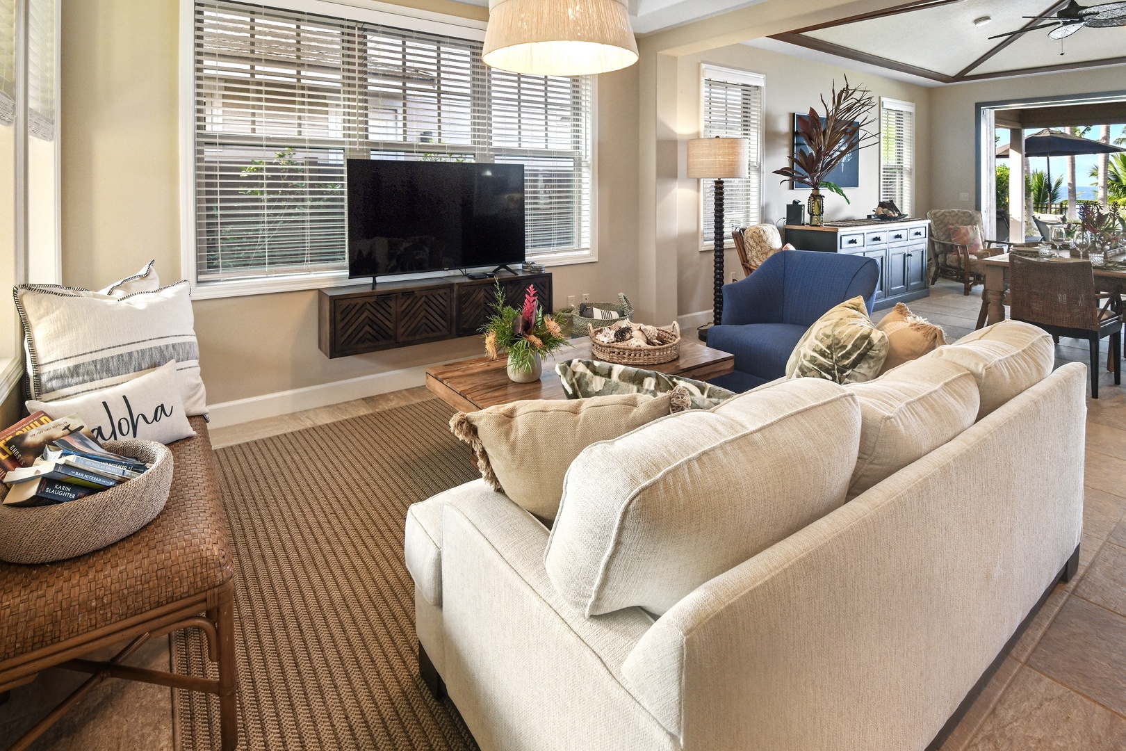 Sink into plush sectional seating in your open-concept living space, where modern comfort meets tropical elegance with thoughtful Hawaiian touches.