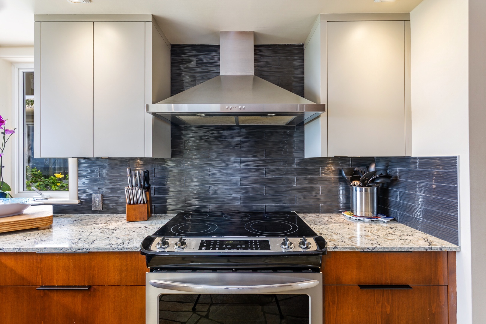Prepare your favorite meals in this modern kitchen with sleek granite countertops, stainless-steel appliances, and contemporary finishes that make cooking a pleasure.