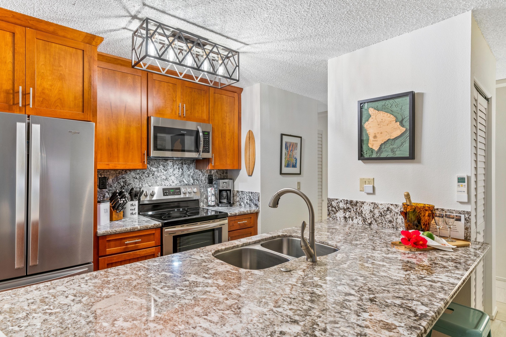 Your fully-equipped kitchen features granite countertops, stainless steel appliances, and warm wood cabinetry—everything you need to prepare meals during your island getaway.