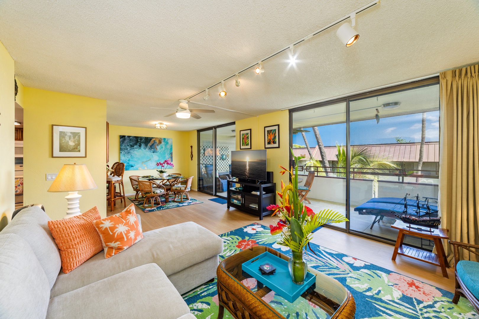 Sink into comfort in your bright, island-inspired living space, where tropical colors and cozy furnishings invite you to unwind. Step through the glass doors to your private balcony with a refreshing pool view.