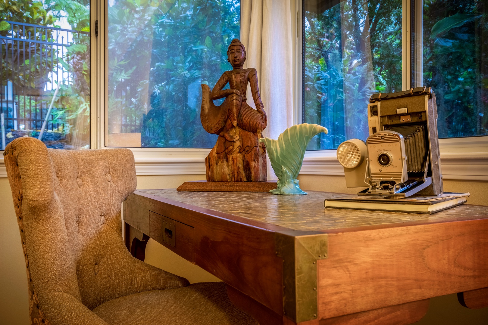 Settle into your tranquil workspace, surrounded by curated art and serene garden views—where inspiration flows as naturally as morning light through these windows.