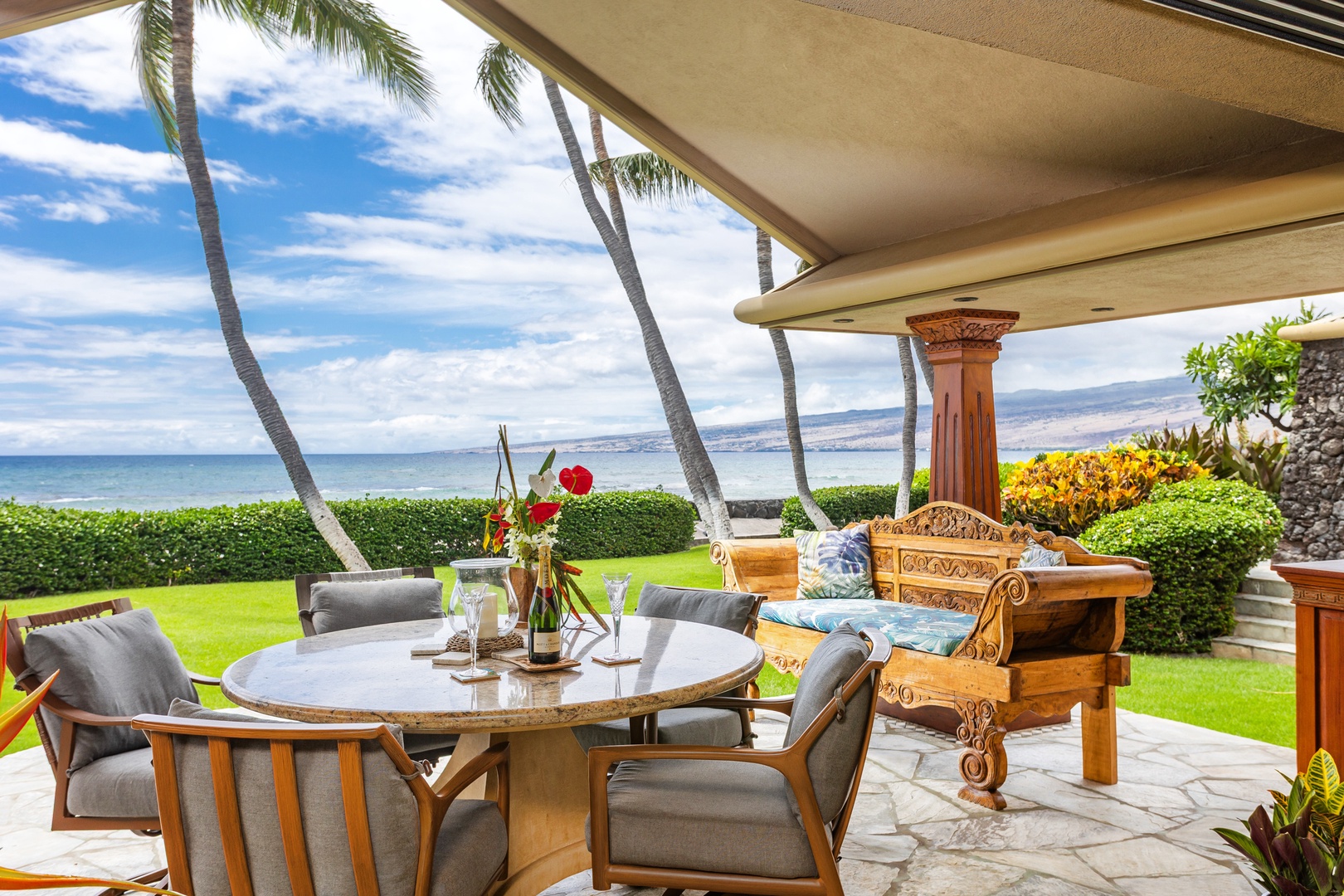 Your private lanai overlooks manicured lawns and swaying palms, with sparkling ocean views stretching to distant mountains—perfect for morning coffee or sunset cocktails.