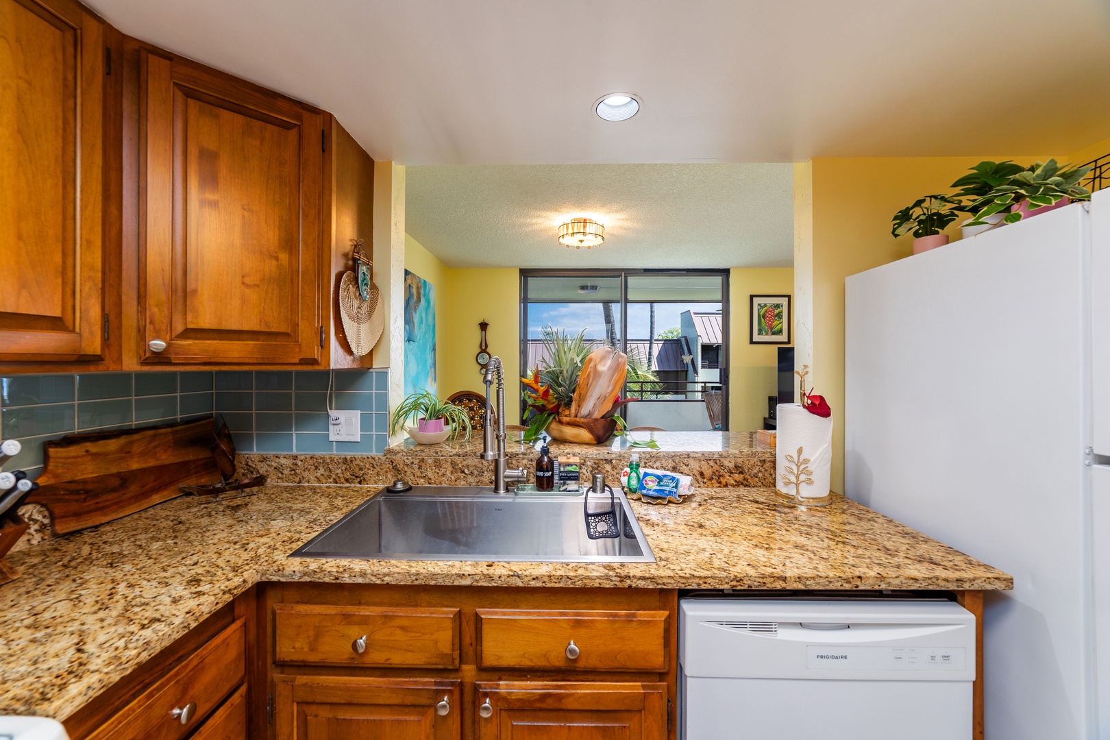 Your fully equipped kitchen with granite countertops and warm wood cabinetry opens to a sunny private balcony—perfect for making yourself at home.