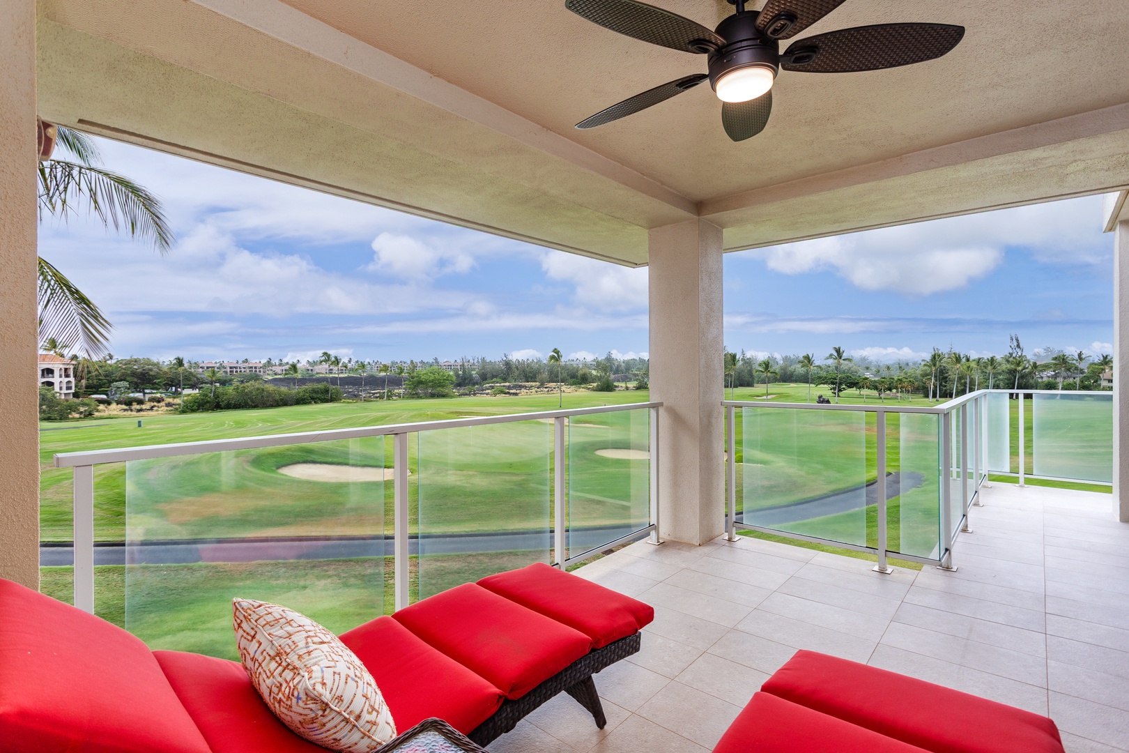 Unwind on your private covered balcony with sweeping views of the golf course. Tropical breezes and bright red lounge seating create an inviting retreat to relax and soak in the lush island scenery.