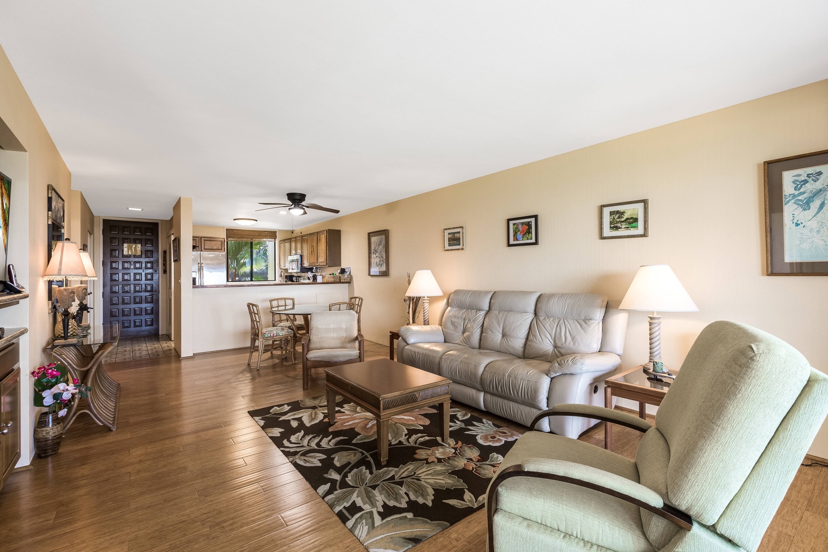 Unwind in your spacious, sunlit living area with comfortable seating, island-inspired decor, and an open layout that flows seamlessly into the fully-equipped kitchen and dining space.