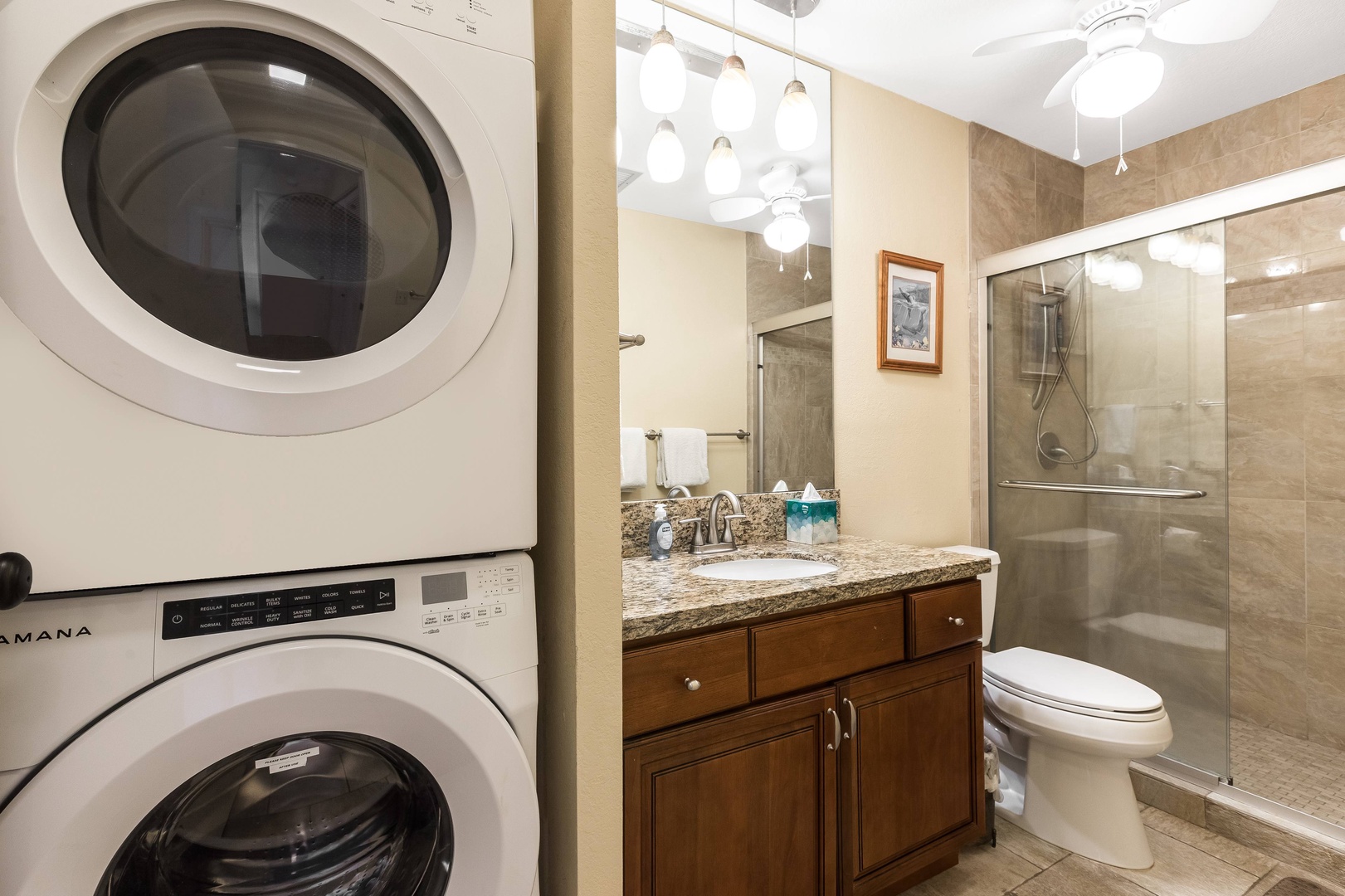 Your private bathroom offers a spacious walk-in shower with modern fixtures, a stylish vanity with granite countertop, and convenient in-unit laundry for your comfort.