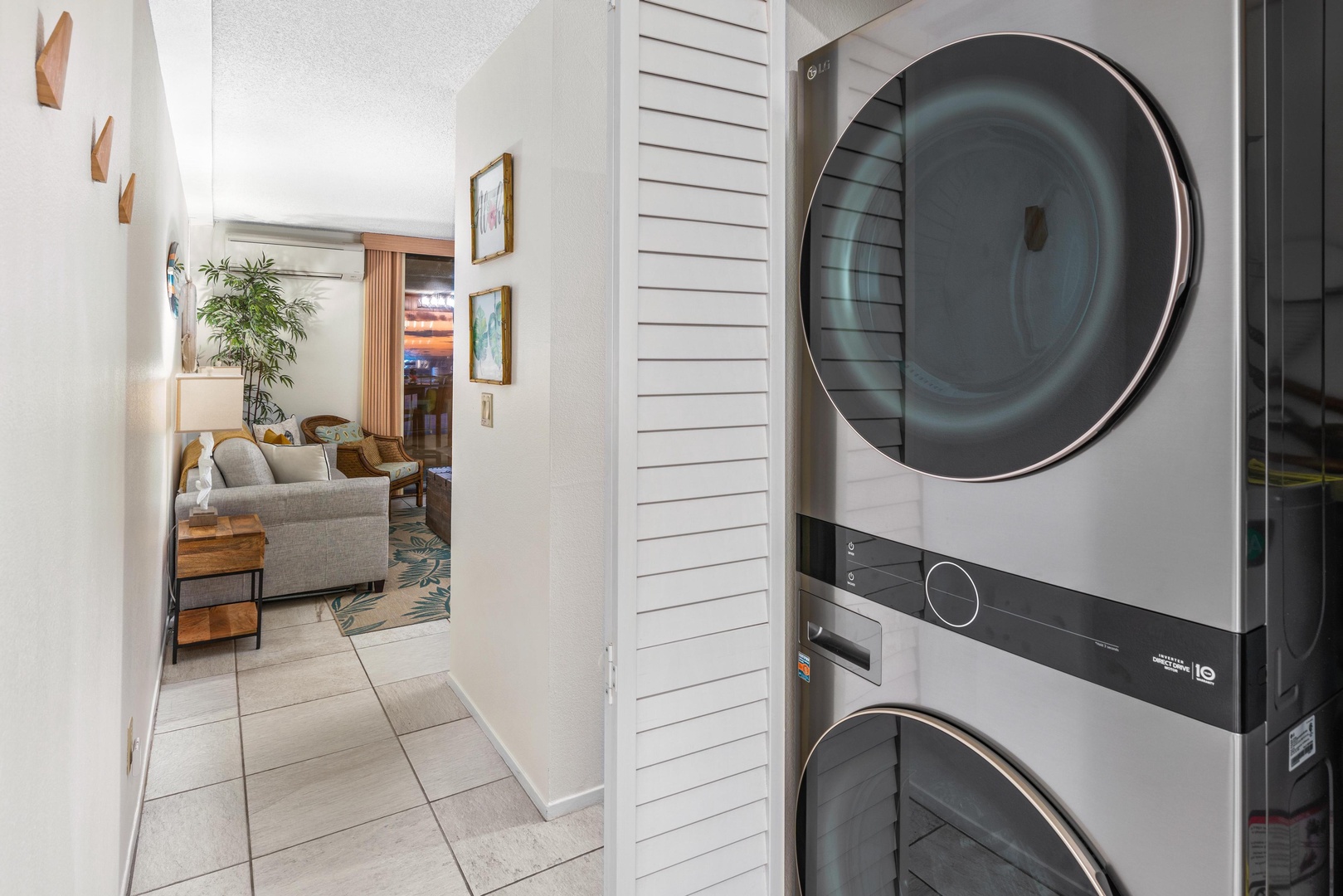 A modern stacked washer and dryer unit makes laundry effortless during your stay, tucked neatly near the living area for easy convenience.
