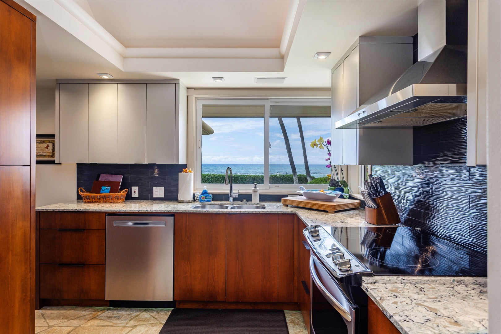 Kitchen - Cook your favorite meals in this fully equipped gourmet kitchen with sleek modern appliances, granite countertops, and stunning ocean views through large windows that bring the outdoors in.