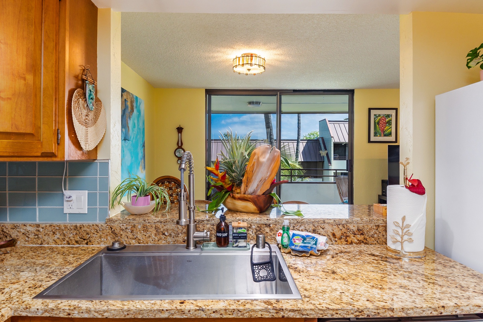 Your bright, fully equipped kitchen features granite counters and cheerful tropical touches, opening to your private balcony where warm breezes and sunny island days await.